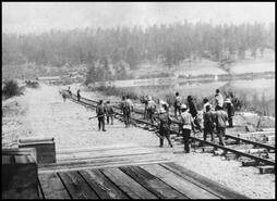 Men laying the rail tracks on the ' Railroad' next to Wood Lake at Oyama
