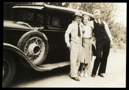 Harold Russell, Beth Gage and Raymond Reynolds posing beside automobile