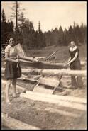 Mary Koller and Edna Sowerby cutting wood at Mamette lake