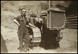 Monty Beaton posing with Cletrac crawler at Demuth camp near Princeton