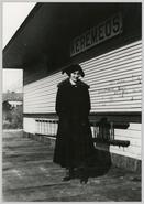 Unidentified woman [May Clifton?] standing at the Keremeos train station