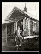 Young man in front of house
