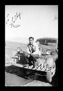 Unidentified man sitting on the front of a truck
