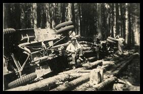 Oscar Blaigh and Harold Taylor with overturned logging truck