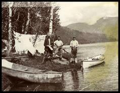Three hunters in camp on lake
