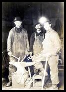 Mine workers in a blacksmith shop