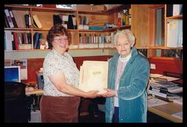 Mary Carne (White) at the Lake Country Museum donating a scrapbook to Rosemary Carter