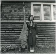 Catherine Lake in her Guide uniform in front of Anglican Christ Church in Invermere