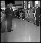 Mayor A.W. Lundell cuts ribbon to open the new Canadian Imperial Bank of Commerce