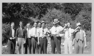 Nine men sharing a drink