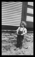 Child (Billo Cahill) holding twig