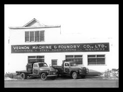Vernon Machine & Foundry Co. Ltd. building with two of the company trucks out front.
