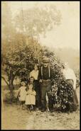 Family beside apple tree