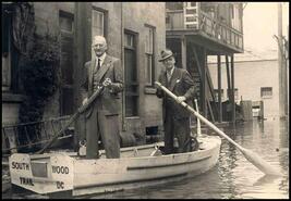 George Rennison and H. Radcliffe in boat behind Crown Point Hotel during 1948 flood