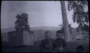 Connie O'Keefe and a boy seated on grass