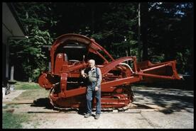 Al McInnes poses in front of TD9 caterpillar tractor/crawler after restoration