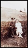 Annie and Alf Lodge in military uniform sitting in a field