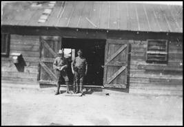 Two men standing in the doorway of the Vernon internment camp guardroom