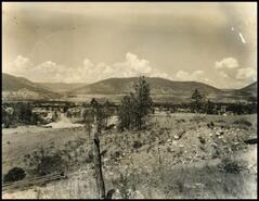 [View of the outskirts of Penticton with pipe along the road]