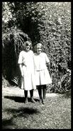 Matilda Schimmel and Daisy Malm (Gronquist) standing in front of a tree