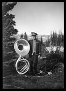 Unidentified Revelstoke Band member with sousaphone at summit of Mount Revelstoke