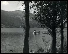Group of people in a runabout on Christina Lake,