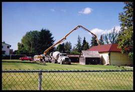 Pouring cement between the Lake Country Museum and the annex