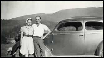 Lea & Bert Johnson beside automobile