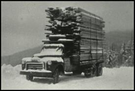 Truck loaded with lumber in winter