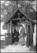 Two women under the Lych Gate of St. George's Anglican Church