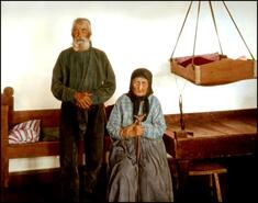 Doukhobor deda (grandfather) and baba (grandmother) beside hanging cradle