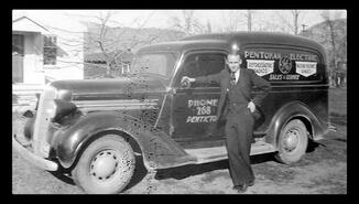 Harold Butterworth beside a Pentokan Electric truck