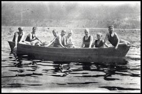 Group of swimmers in row boat on Nicola Lake