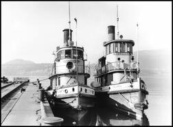 Tugboats S.S. Kelowna and S.S. Naramata tugs docked at the Kelowna wharf
