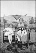 Sisters Elizabeth and Sine Armstrong under paper umbrella