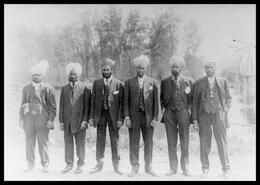 Group of East Indian men who worked at the WX Ranch in front of the bridge at Enderby