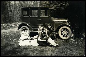 Inez Stevenson, Mary Stevenson, Daisy Malm (Gronquist), Mrs. Stevenson beside car having a picnic