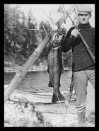 H.B. Kennard showing off the large fish he caught on Okanagan Lake