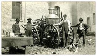 Postcard of group with of fire department steam pumper