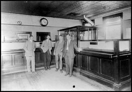 Group of men inside Bank of Commerce