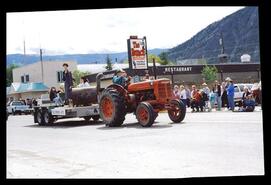 John Biro driving tractor pulling Museum float