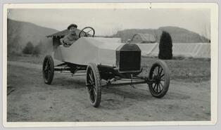 Fred Graham in hand built automobile