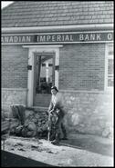 G. Hillecke with jack-hammer in front of Canadian Imperial Bank of Commerce, Invermere