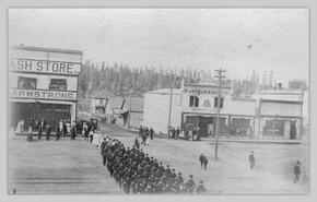 Parade in front of Big Cash Store and W.J. Boyle Co. Ltd.