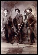 Three men posing in photography studio