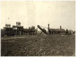 Workers with steam train and steam shovel