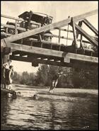Boys diving into river under Collettville bridge