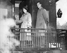 Princess Elizabeth and the Duke of Edinbourgh standing on the back of a railcar during their royal tour of B.C.