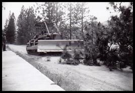 Bulldozer clearing the road in front of what was Peter Short's house