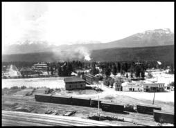 Early view of stores, buildings and 10th Avenue bridge over the Kicking Horse River, Golden, B.C.